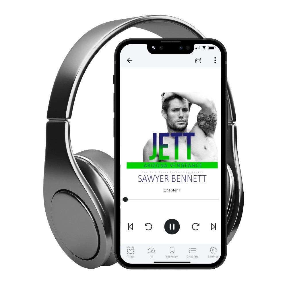 Hockey romance audiobook cover featuring an attractive shirtless man with dark hair and facial scruff, with one hand in his hair and a tattoo on his bicep, displayed on a smartphone with headphones. The title of the book is Jett by New York Times Bestselling Author Sawyer Bennett.