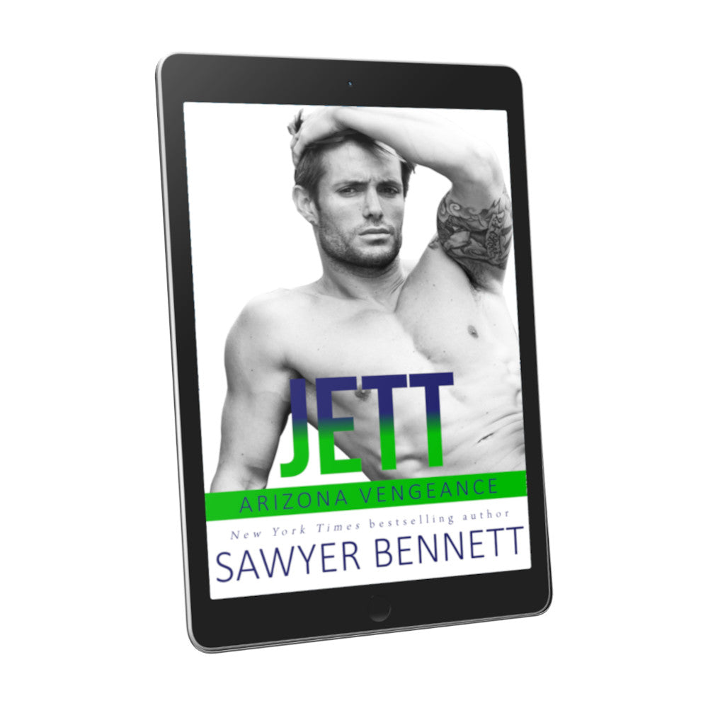 Hockey romance book cover featuring an attractive shirtless man with dark hair and facial scruff, with one hand in his hair and a tattoo on his bicep, displayed on an e-reader. The title of the book is Jett by New York Times Bestselling Author Sawyer Bennett.