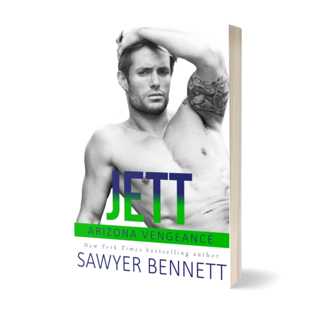 Hockey romance paperback featuring an attractive shirtless man with dark hair and facial scruff, with one hand in his hair and a tattoo on his bicep. The title of the book is Jett by New York Times Bestselling Author Sawyer Bennett.