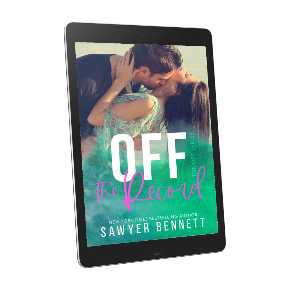 Contemporary romance book cover featuring an attractive couple in their mid-20’s embracing, displayed on an e-reader. The title of the book is Off the Record by New York Times Bestselling Author Sawyer Bennett.