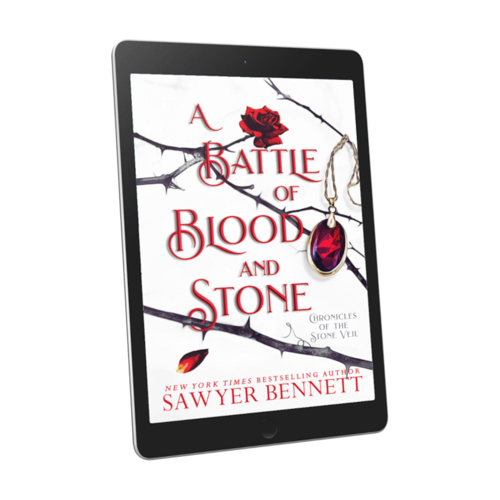 Fantasy romance book cover with thorned branches sprawled across a white background and blood red amulet hanging from one of the branches, displayed on an e-reader. The title of the book is A Battle of Blood and Stone by New York Times Bestselling Author Sawyer Bennett.