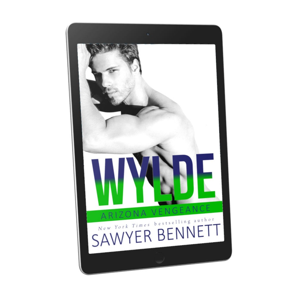 Hockey romance book cover featuring an attractive man with dark hair and facial scruff, shirtless with both forearms leaning on a wall, displayed on an e-reader. The title of the book is Wylde by New York Times Bestselling Author Sawyer Bennett.