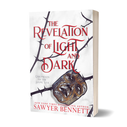 Fantasy romance paperback with thorned branches sprawled across a white background with a mask hanging on one of the branches. The title of the book is The Revelation of Light and Dark by New York Times Bestselling Author Sawyer Bennett.