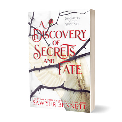 Fantasy romance paperback with thorned branches sprawled across a white background with white angel wings. The title of the book is A Discovery of Secrets and Fate by New York Times Bestselling Author Sawyer Bennett.