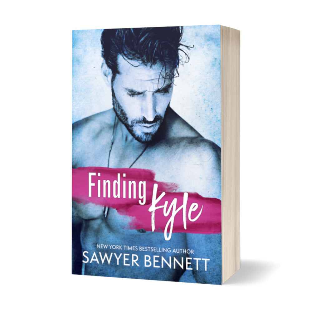 Contemporary romance paperback featuring an attractive shirtless man wearing only a black leather necklace. He has dark hair and a dark beard and is looking down and off to the side. The title of the book is Finding Kyle by New York Times Bestselling Author Sawyer Bennett.