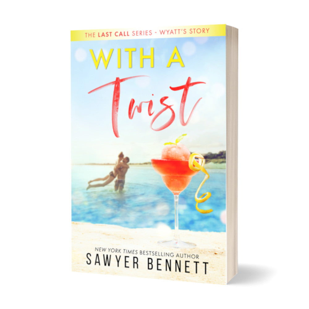 Contemporary romance paperback featuring a couple embracing on the beach in the background, with a tall glass with an orange frozen drink and a twist of lemon in the forefront. The title of the book is With a Twist by New York Times Bestselling Author Sawyer Bennett.