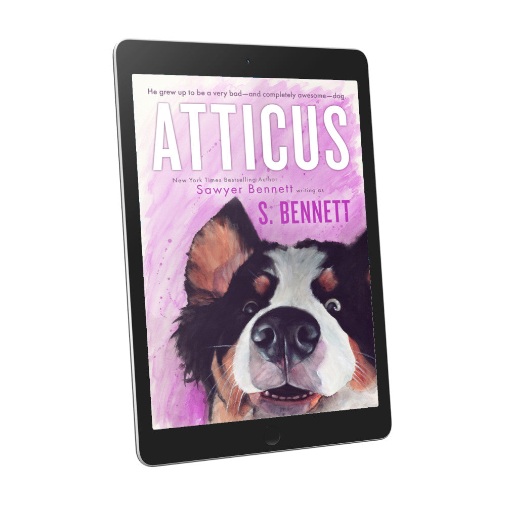 A woman’s fiction book cover featuring a watercolor painting of a Bernese Mountain Dog’s face. The dog has a slight smile on his face and his eyes are two different colors—one blue and one brown, displayed on an e-reader. The title of the book is Atticus by New York Times Bestselling Author Sawyer Bennett.