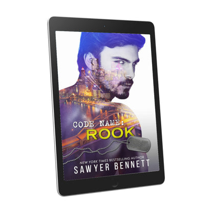 Romantic suspense book cover featuring an attractive man and city scape, displayed on an e-reader. The title of the book is Code Name: Rook by New York Times Bestselling Author Sawyer Bennett.