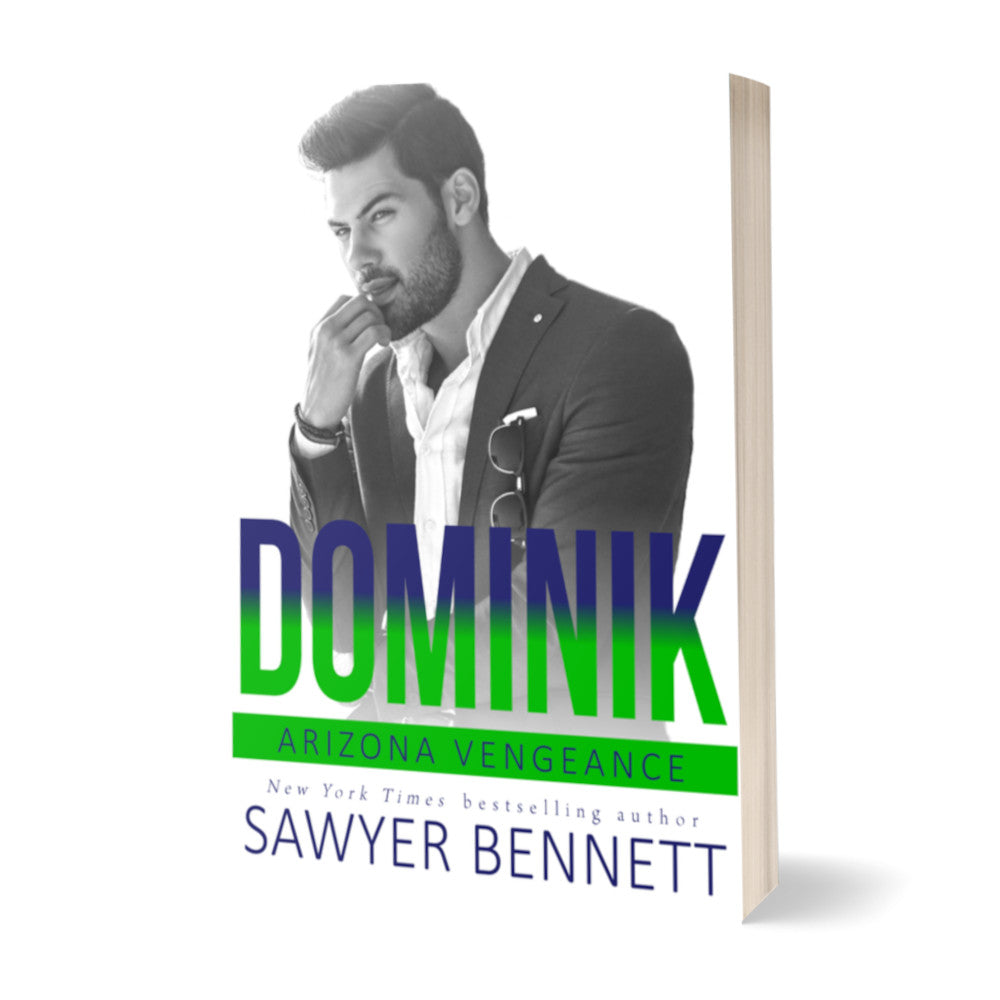 Hockey romance paperback featuring an attractive man with dark hair and a dark beard, wearing a black suit and white shirt open at the collar. The title of the book is Dominik by New York Times Bestselling Author Sawyer Bennett.