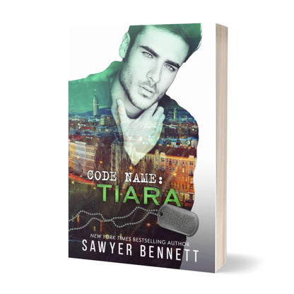 Romantic suspense paperback featuring an attractive man and city scape. The title of the book is Code Name: Tiara by New York Times Bestselling Author Sawyer Bennett.