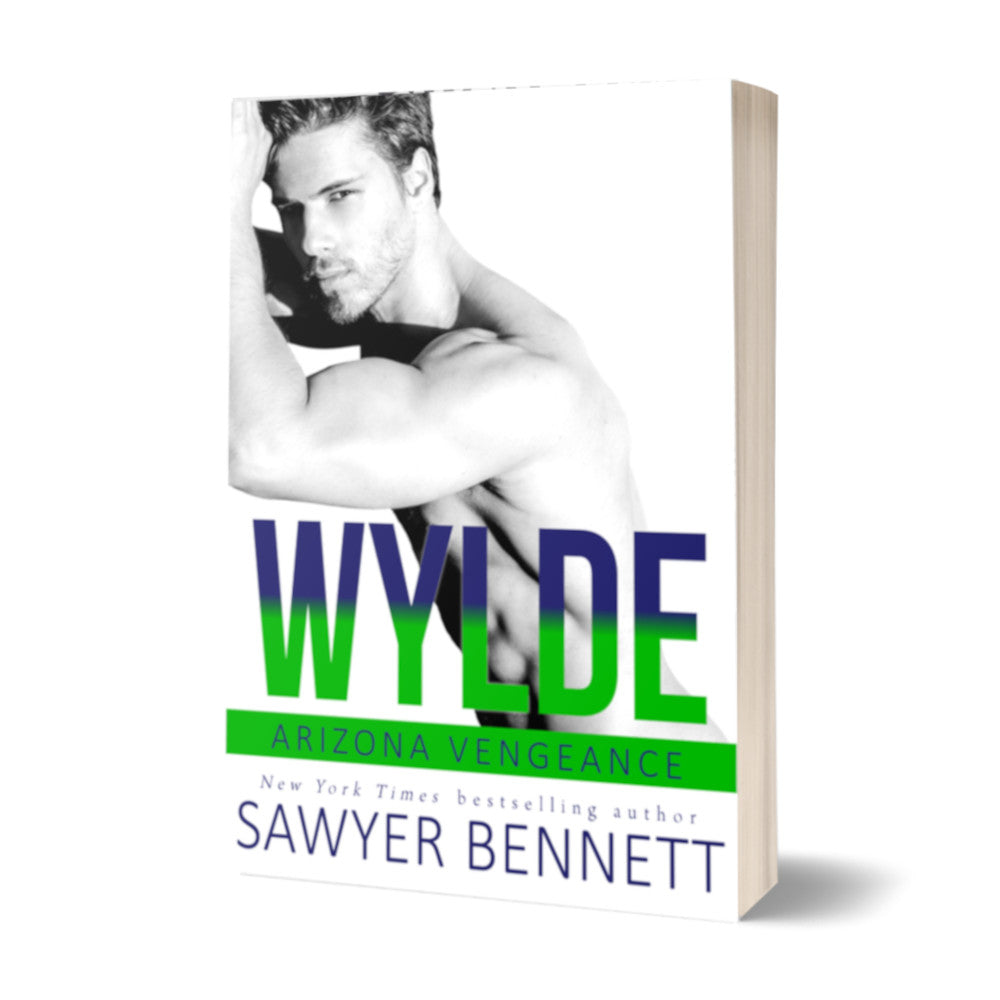 Hockey romance paperback featuring an attractive man with dark hair and facial scruff, shirtless with both forearms leaning on a wall. The title of the book is Wylde by New York Times Bestselling Author Sawyer Bennett.