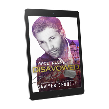 Romantic suspense book cover featuring an attractive man and city scape, displayed on an e-reader. The title of the book is Code Name: Disavowed by New York Times Bestselling Author Sawyer Bennett.