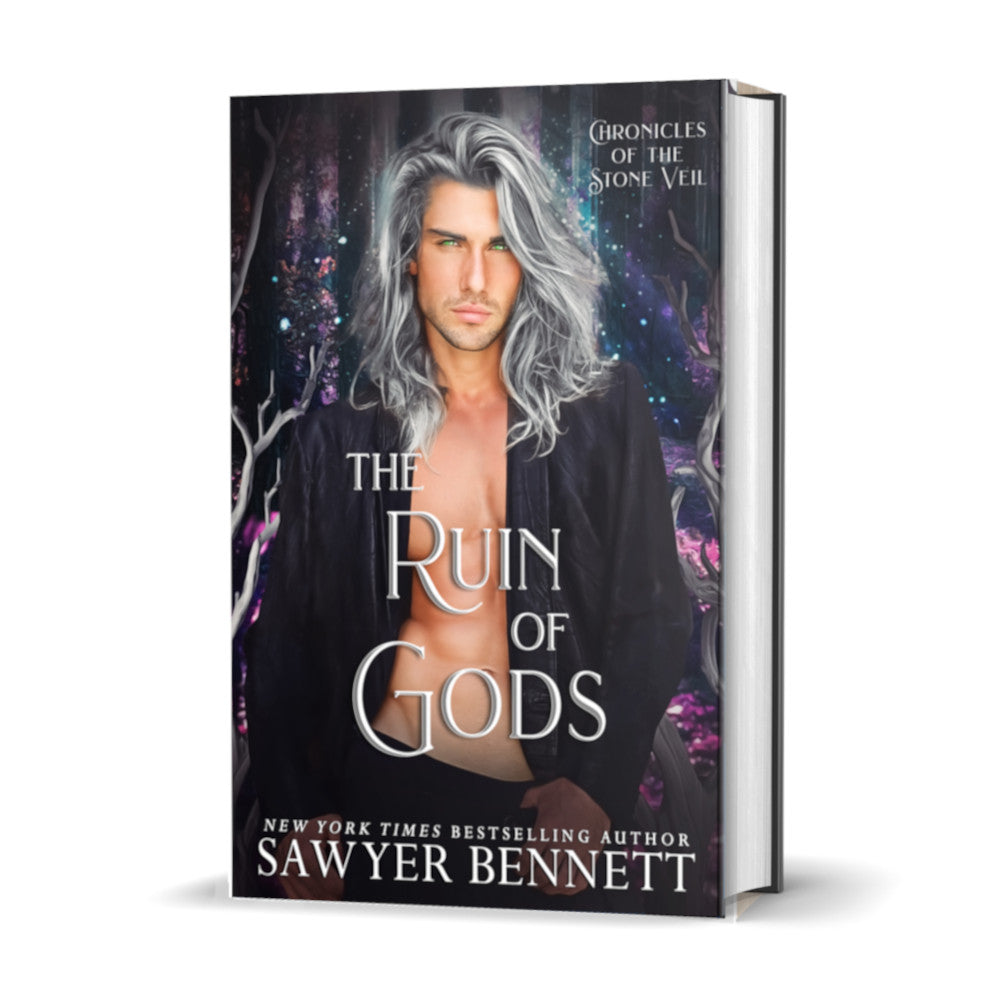 Fantasy romance hardcover with a dark background with flecks of pinks, purples and blues and attractive man with long, gray hair wearing a black leather jacket open to reveal a bare chest. The title of the book is The Ruin of Gods by New York Times Bestselling Author Sawyer Bennett.